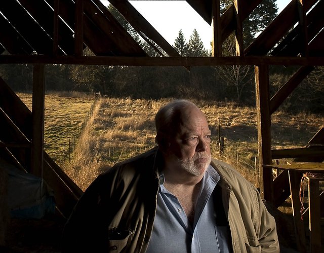 Chuck Cushman, executive director of the American Land Rights Association, stands inside an old barn on his Battle Ground property.Hes fighting against Rialto Capital Management in hopes of spurring changes in how the government handles bank closures. 